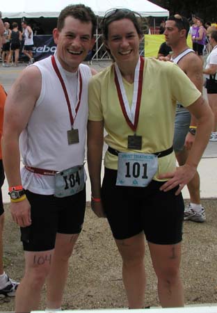 ChicagoTriathlon2004U_TamAndSteveMedalsAndNumbers