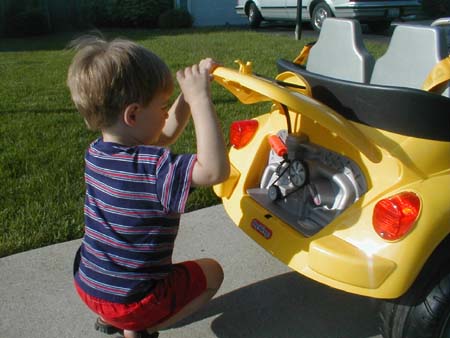 AvynCheckingEngineOfLittleYellowCar_May2003